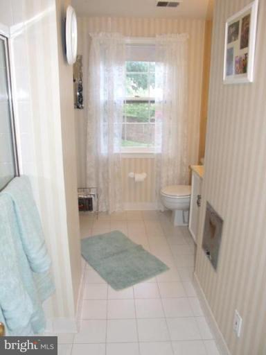 12409 Over Ridge Road Potomac, MD 20854 - Photo 20 of 30 a bathroom with a sink a toilet a window and a shower