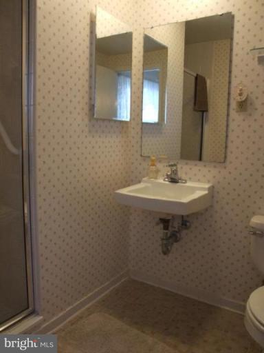 12409 Over Ridge Road Potomac, MD 20854 - Photo 3 of 30 a bathroom with a sink a toilet and mirror