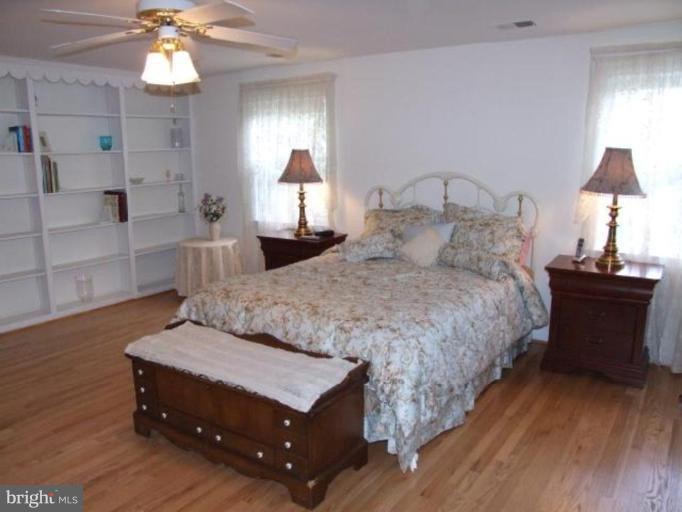 12409 Over Ridge Road Potomac, MD 20854 - Photo 21 of 30 a bedroom with a bed and a lamp