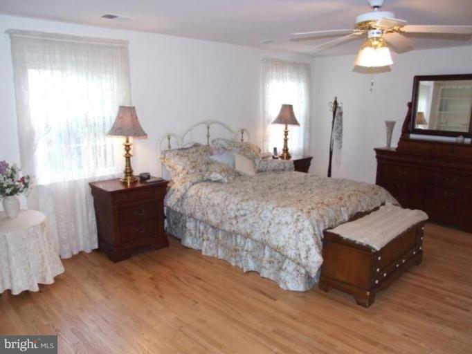 12409 Over Ridge Road Potomac, MD 20854 - Photo 22 of 30 a bedroom with a bed and wooden floor