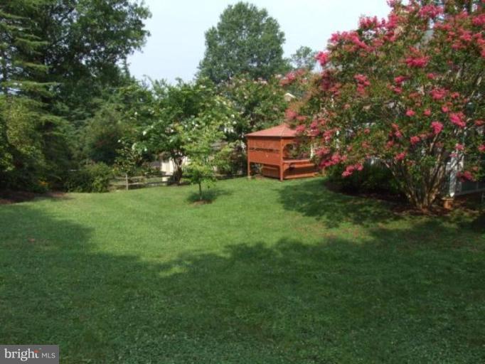 12409 Over Ridge Road Potomac, MD 20854 - Photo 29 of 30 a backyard of a house with table and chairs