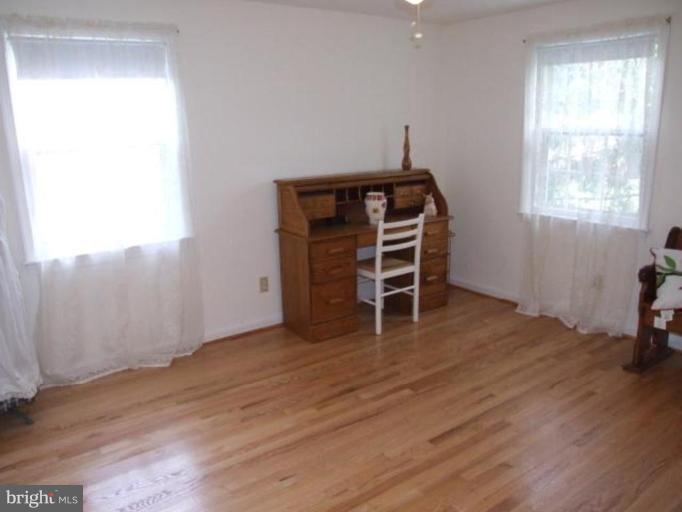 12409 Over Ridge Road Potomac, MD 20854 - Photo 5 of 30 a view of a bedroom with wooden floor and windows