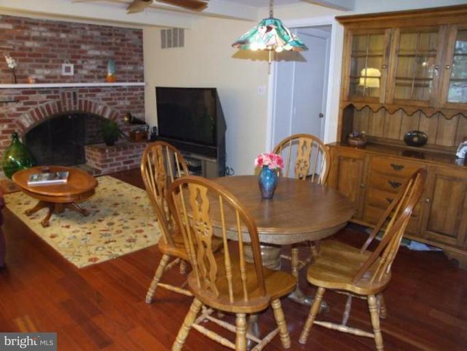 12409 Over Ridge Road Potomac, MD 20854 - Photo 9 of 30 a dining room with furniture a chandelier and wooden floor