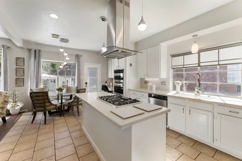 a kitchen with a table chairs and a stove