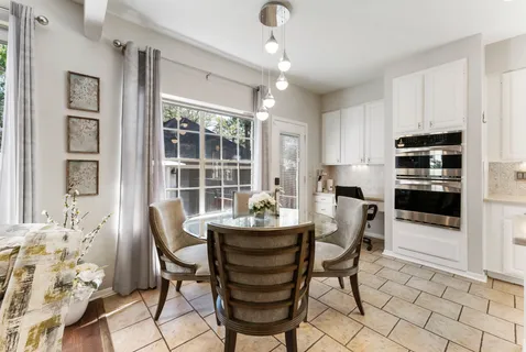 a dining room with furniture and window