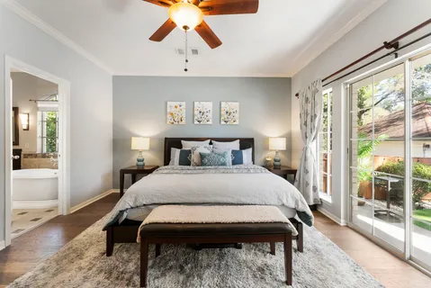 a bedroom with a bed and wooden floor