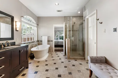 a spacious bathroom with a shower sink and mirror