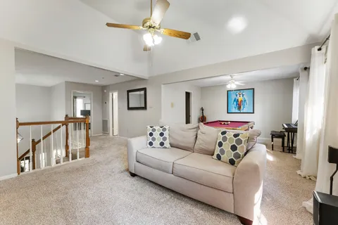 a living room with furniture and a chandelier