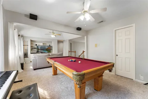 a room with pool table and furniture