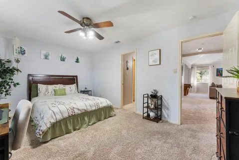 a bedroom with a bed and ceiling fan