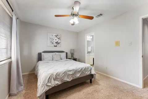 a bedroom with a bed and window