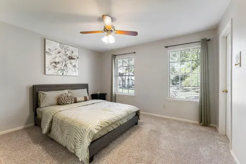 a bedroom with a large bed and a window