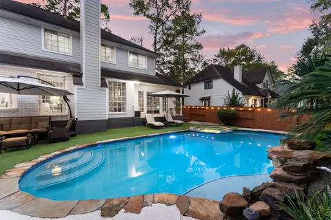 a view of a house with swimming pool yard and sitting area