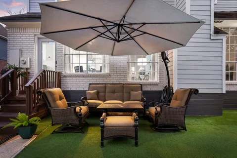 a backyard of a house with table and chairs