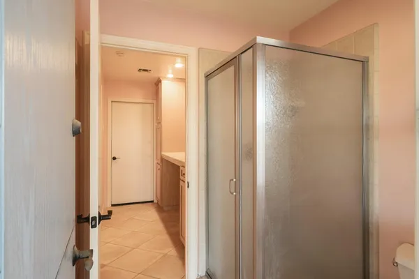 a bathroom with a glass shower door