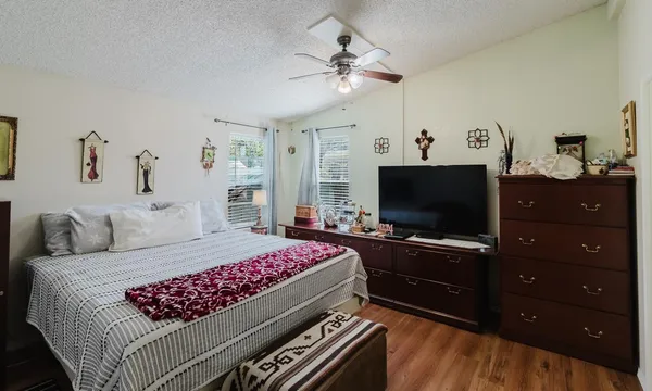 a bedroom with a bed and a flat screen tv