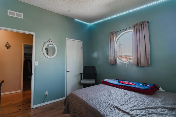 a bedroom with a bed and flat screen tv