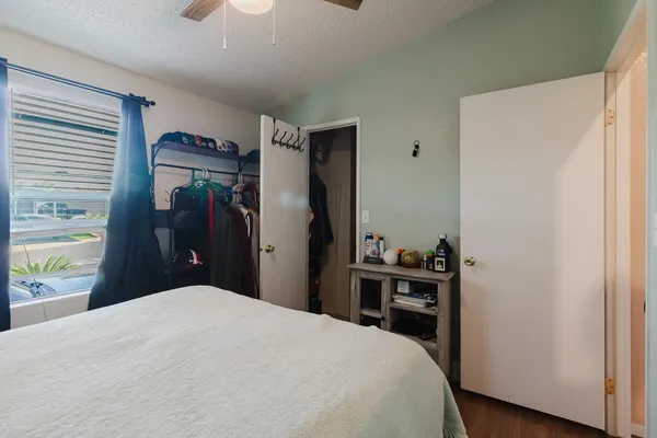 a bedroom with a bed and a desk