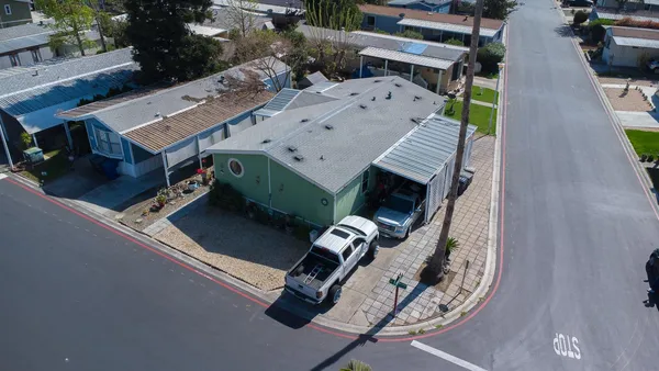 an aerial view of a house with a yard and balcony