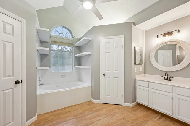 a bathroom with a sink a mirror and a bathtub