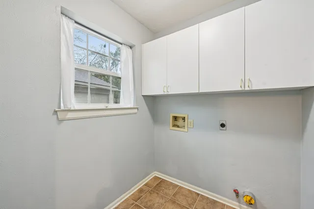 a view of storage and utility room with window