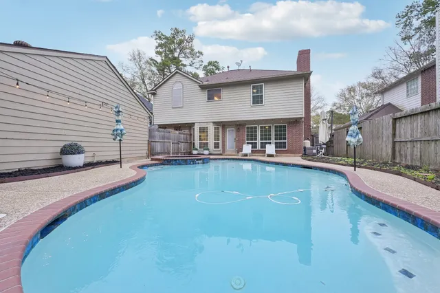 a view of a house with swimming pool and sitting area