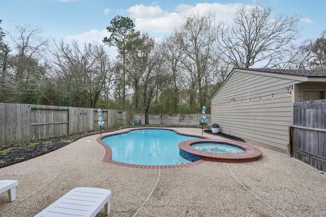 a view of a backyard with swimming pool