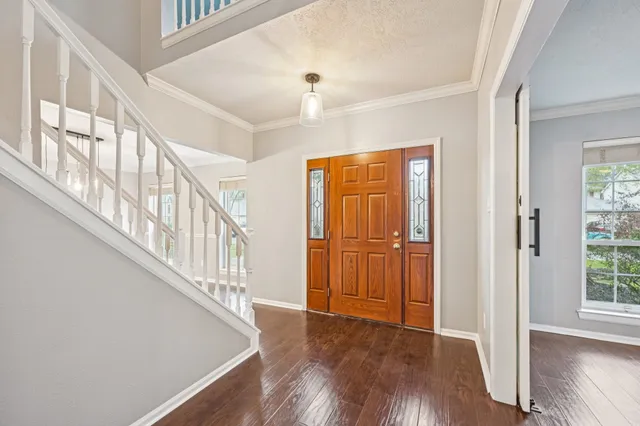 a view of an entryway with wooden floor and door
