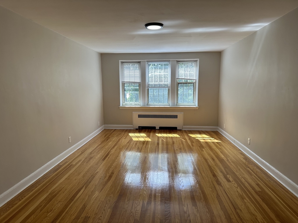 24 Concord Avenue, Unit 111 Cambridge, MA 02138 - Photo 1 of 17 a view of empty room with wooden floor and fan