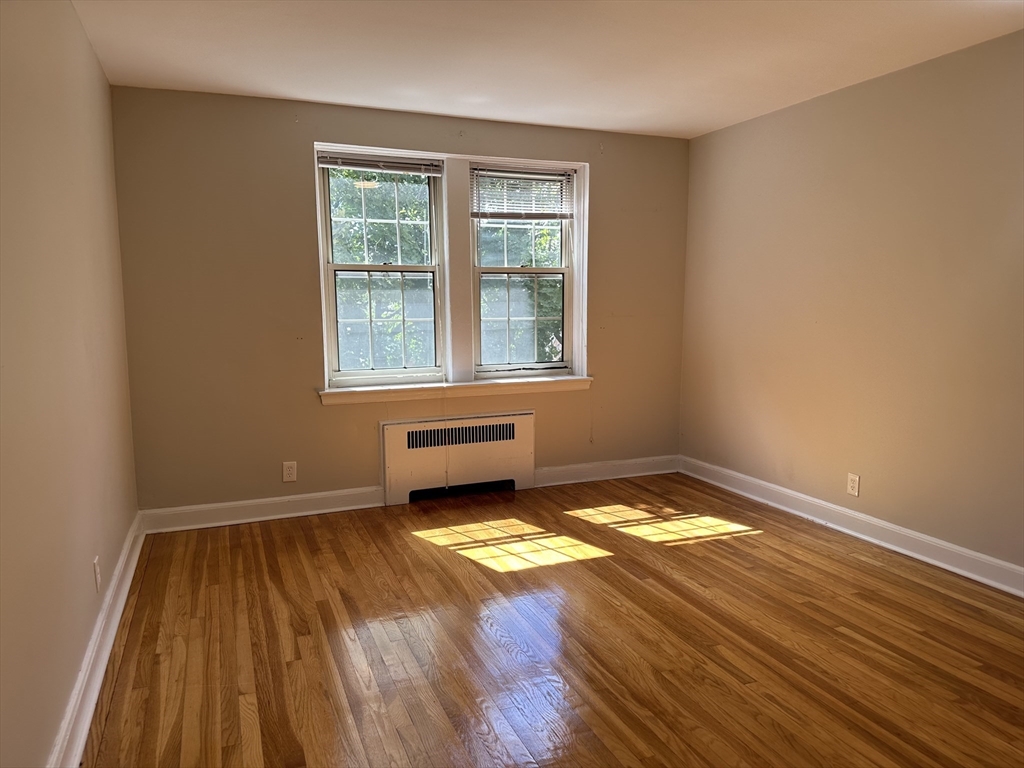 24 Concord Avenue, Unit 111 Cambridge, MA 02138 - Photo 12 of 17 a view of a room with wooden floor and a window