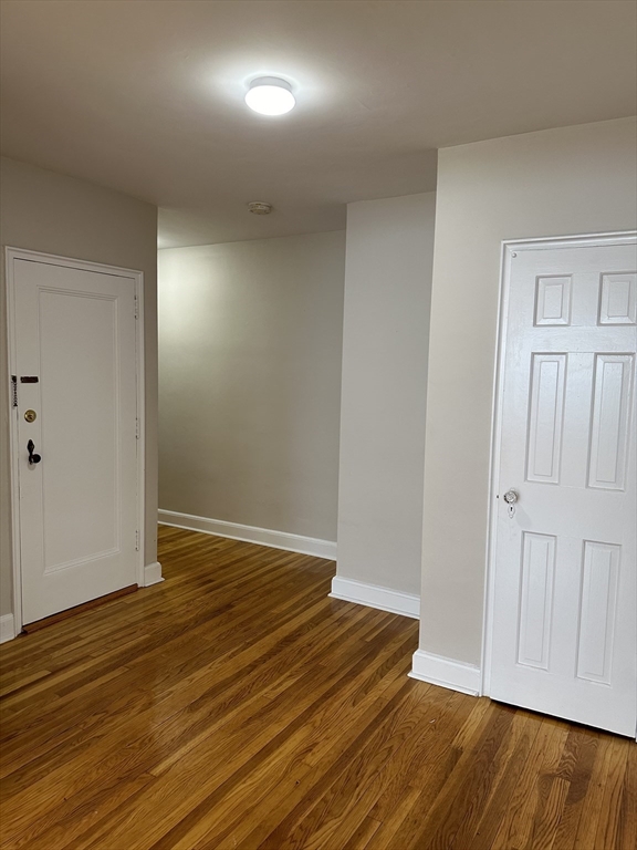 24 Concord Avenue, Unit 111 Cambridge, MA 02138 - Photo 5 of 17 a view of an empty room with wooden floor