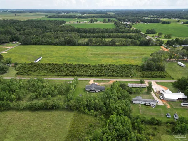 an aerial view of a houses with outdoor view and green mountains
