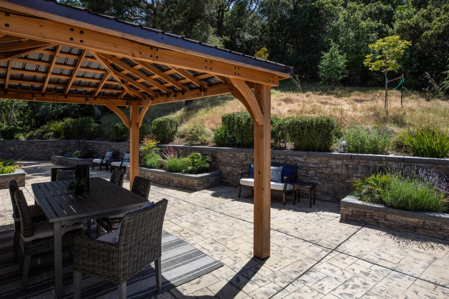 345 Harcross Road Woodside, CA 94062 - Photo 26 of 37 a patio with wooden floor a yard a table and chairs