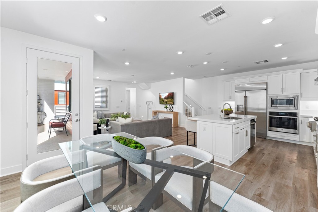 22 Transport Tustin, CA 92782 - Photo 13 of 44 a kitchen with a table and chairs in it