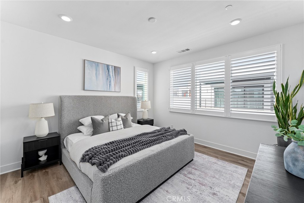 22 Transport Tustin, CA 92782 - Photo 18 of 44 a bedroom with a bed and wooden floor