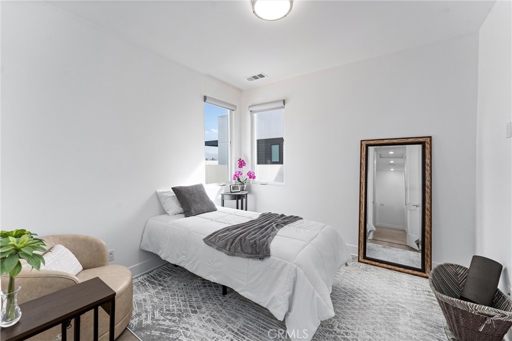 22 Transport Tustin, CA 92782 - Photo 22 of 44 a bedroom with a bed and a couch