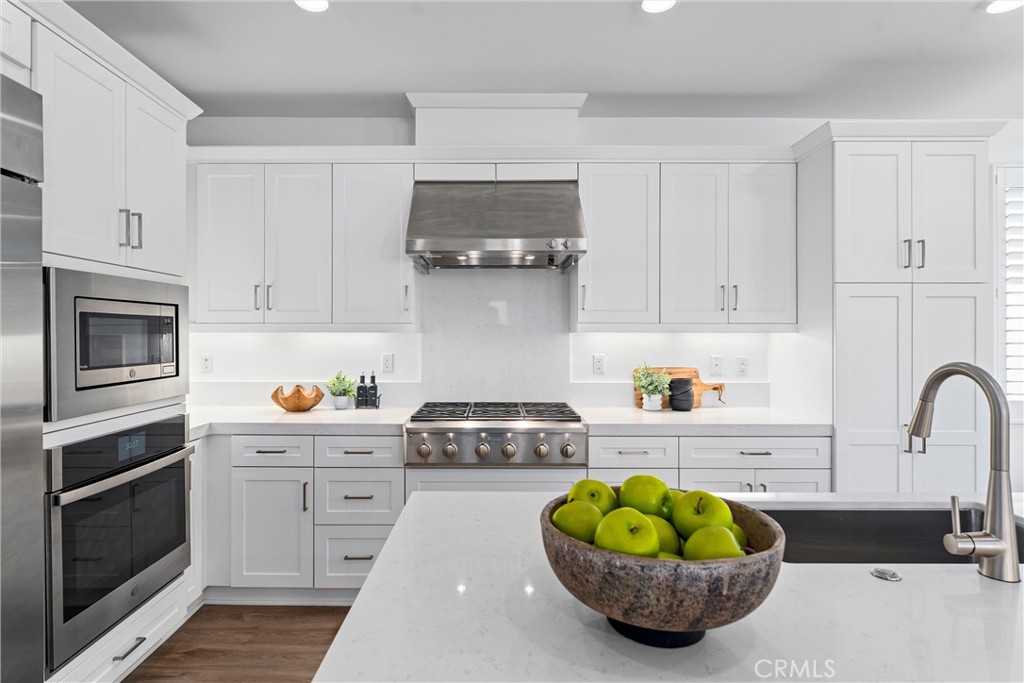 22 Transport Tustin, CA 92782 - Photo 6 of 44 a kitchen with a sink a stove and cabinets