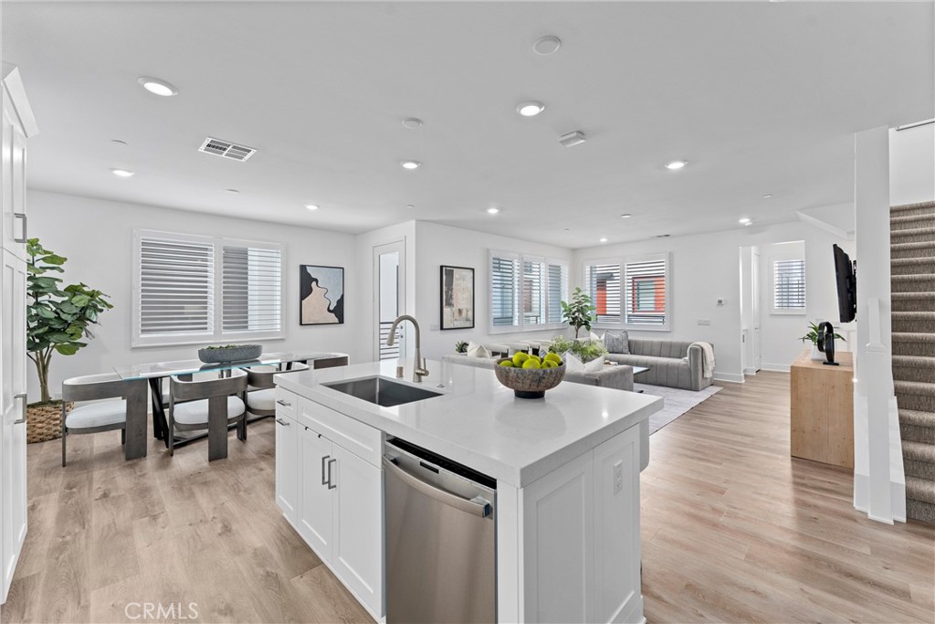 22 Transport Tustin, CA 92782 - Photo 7 of 44 a view of a kitchen with kitchen island a stove a refrigerator a table and chairs