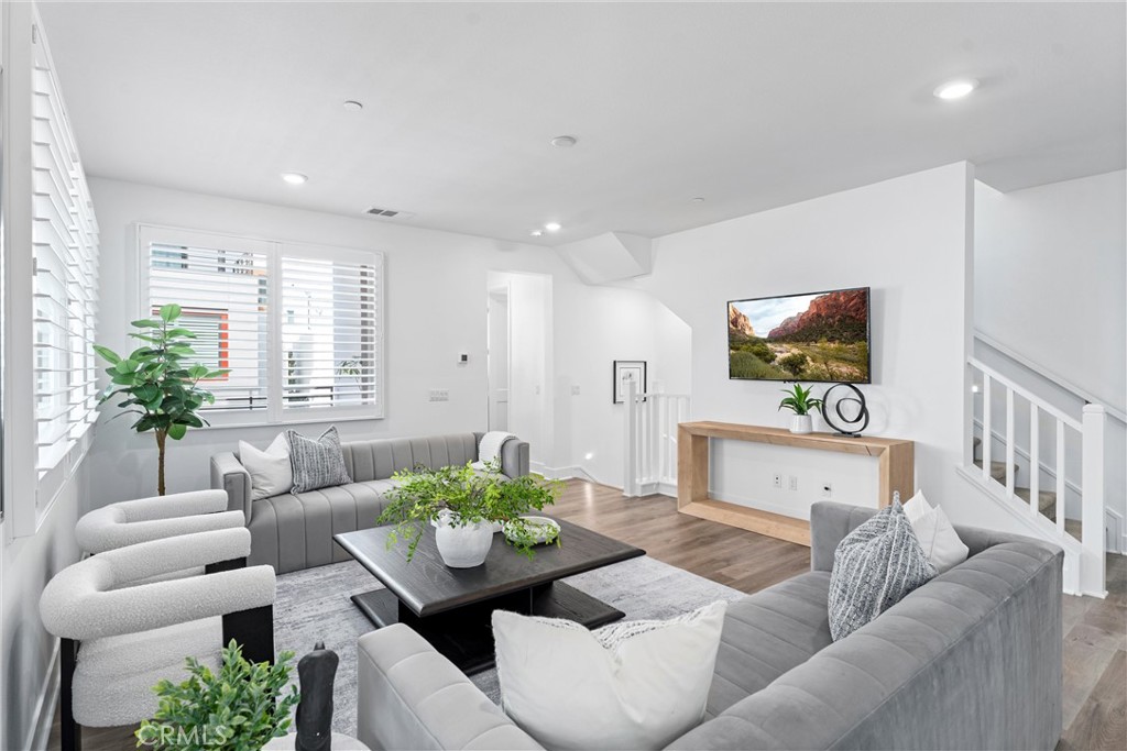 22 Transport Tustin, CA 92782 - Photo 8 of 44 a living room with furniture and a flat screen tv