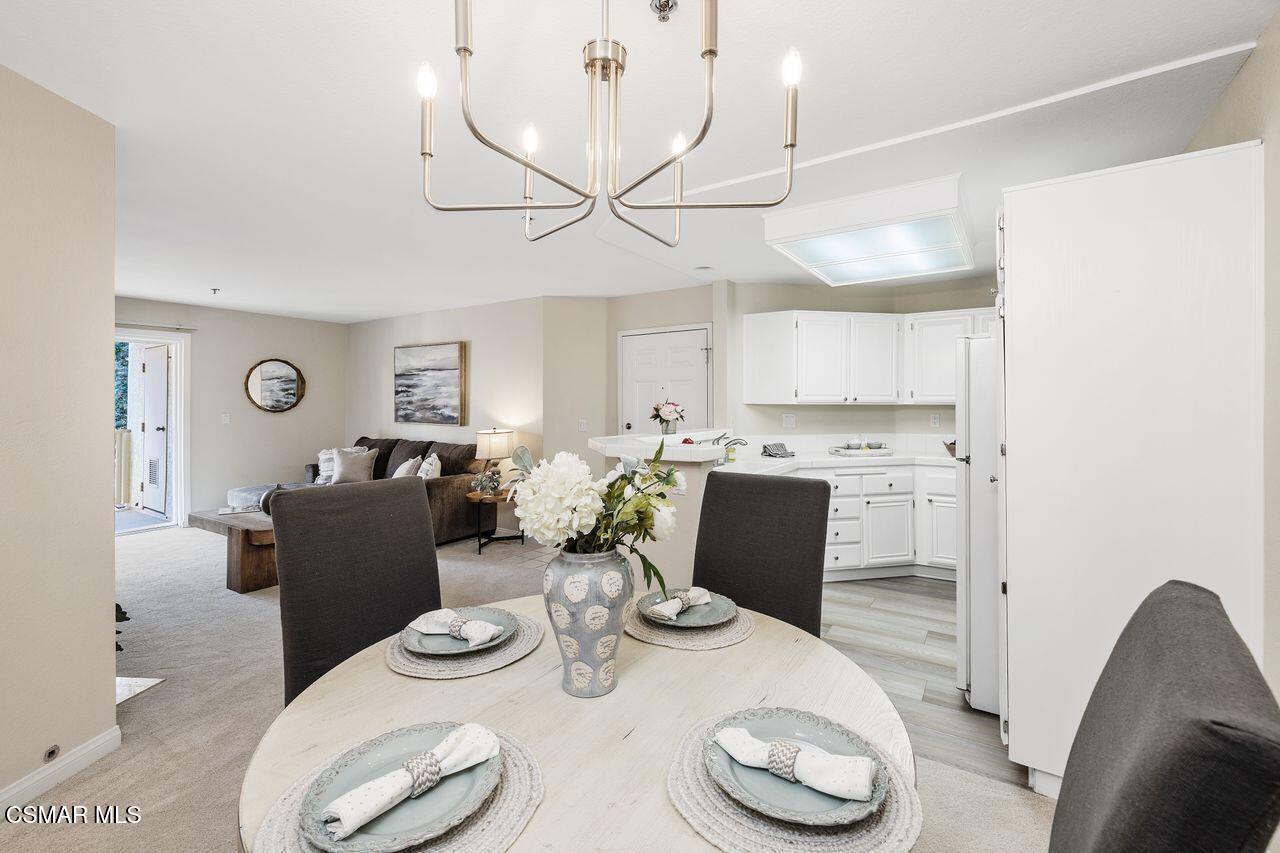 697 Sutton Crest Trail, Unit 302 Oak Park, CA 91377 - Photo 16 of 47 a dining room with furniture and wooden floor