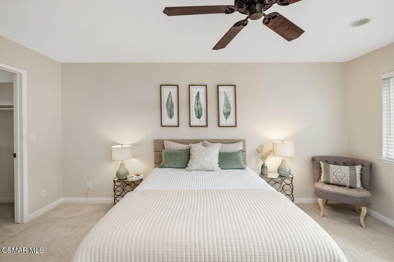 697 Sutton Crest Trail, Unit 302 Oak Park, CA 91377 - Photo 21 of 47 a bedroom with a bed and lamp