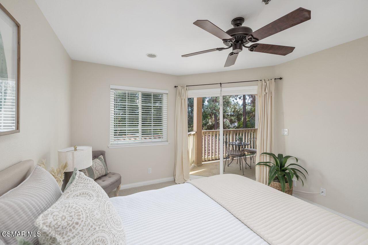 697 Sutton Crest Trail, Unit 302 Oak Park, CA 91377 - Photo 22 of 47 a bed sitting in a bedroom next to a window