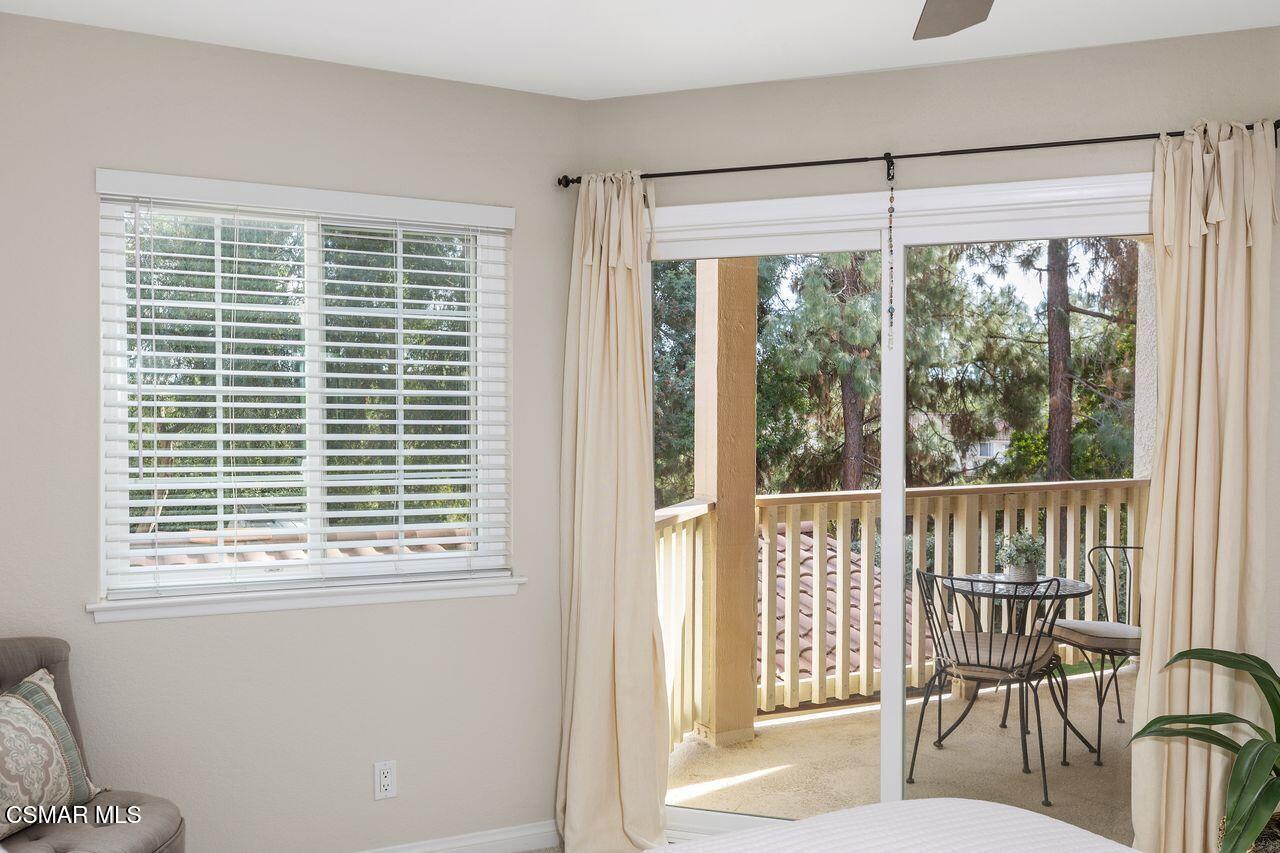 697 Sutton Crest Trail, Unit 302 Oak Park, CA 91377 - Photo 23 of 47 a view of a room that has a bed and a window