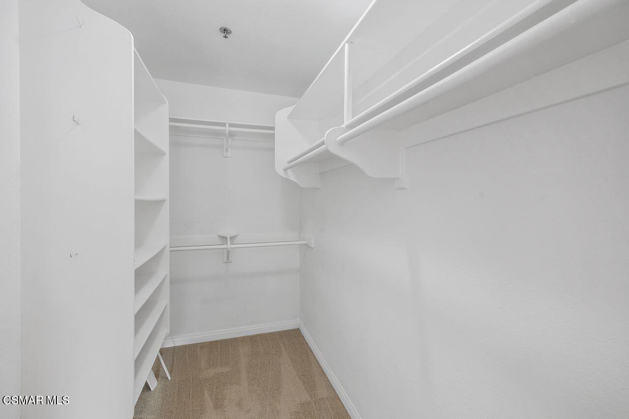 697 Sutton Crest Trail, Unit 302 Oak Park, CA 91377 - Photo 24 of 47 a view of walk in closet with empty racks