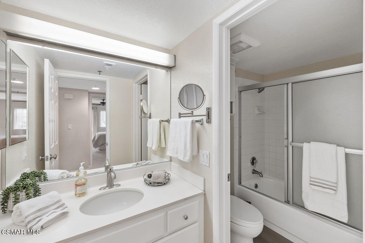 697 Sutton Crest Trail, Unit 302 Oak Park, CA 91377 - Photo 25 of 47 a bathroom with a sink a toilet and shower
