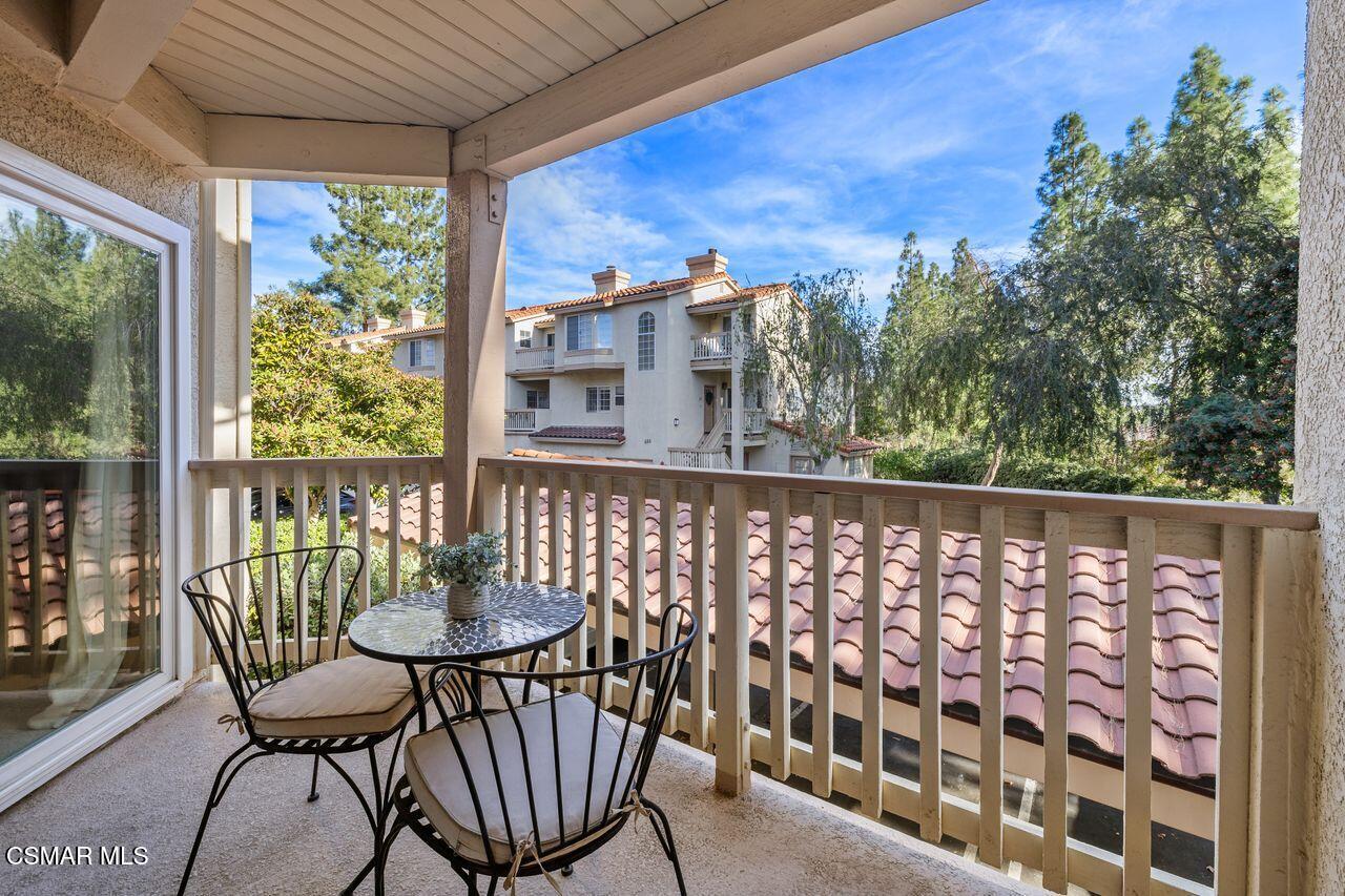 697 Sutton Crest Trail, Unit 302 Oak Park, CA 91377 - Photo 26 of 47 a view of a chair and table in the balcony