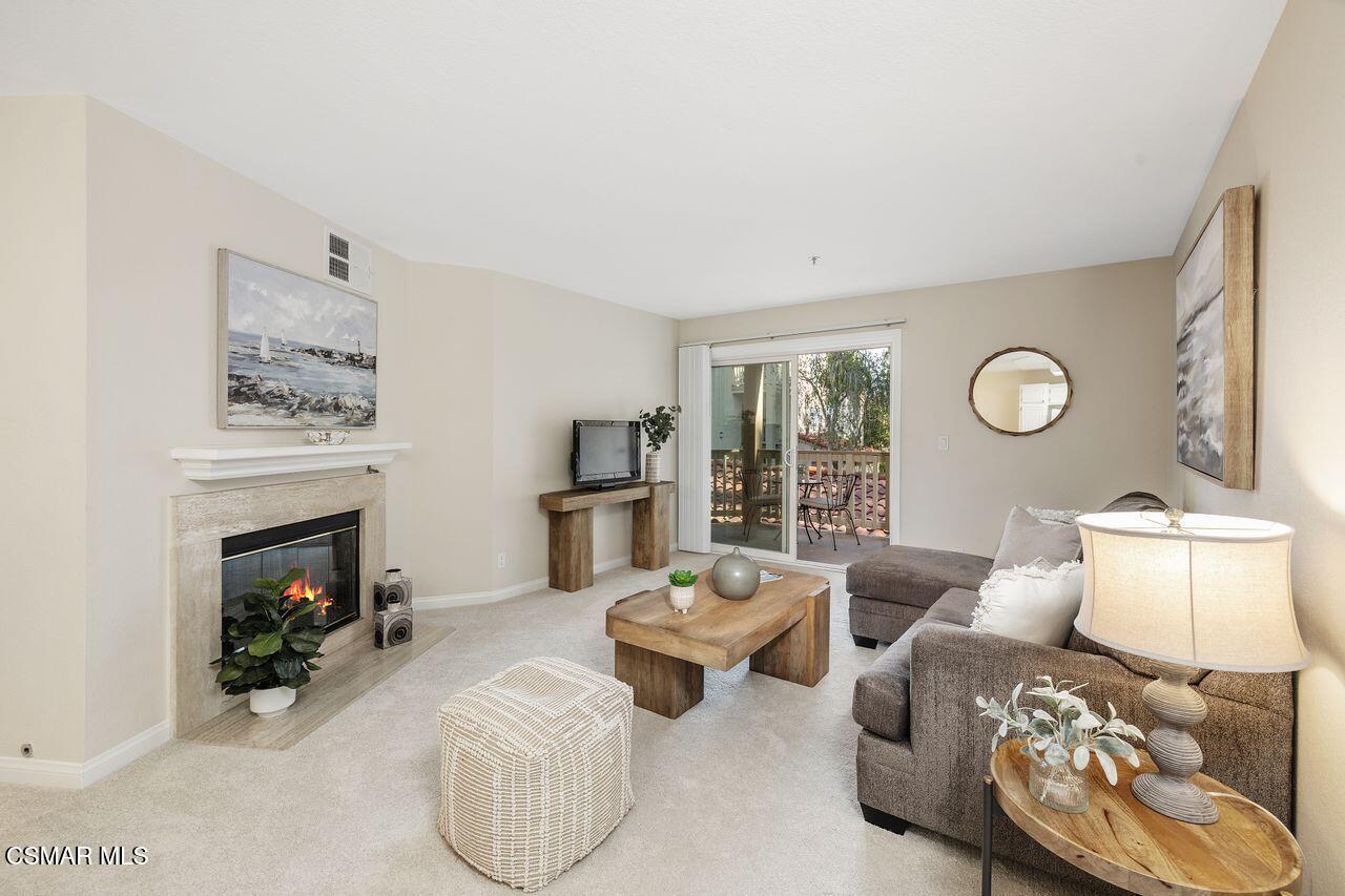 697 Sutton Crest Trail, Unit 302 Oak Park, CA 91377 - Photo 3 of 47 a living room with furniture and a fireplace