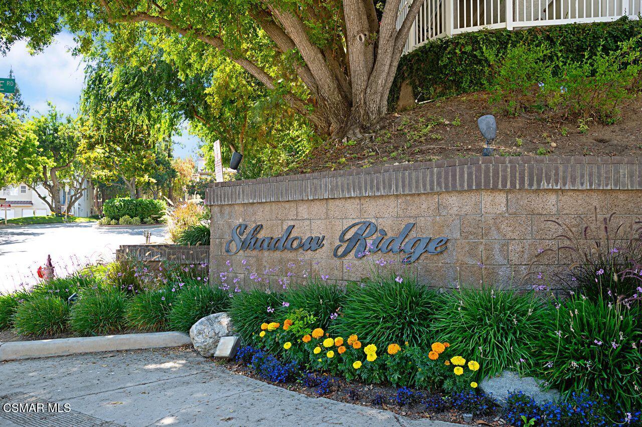 697 Sutton Crest Trail, Unit 302 Oak Park, CA 91377 - Photo 31 of 47 a sign on the side of a building