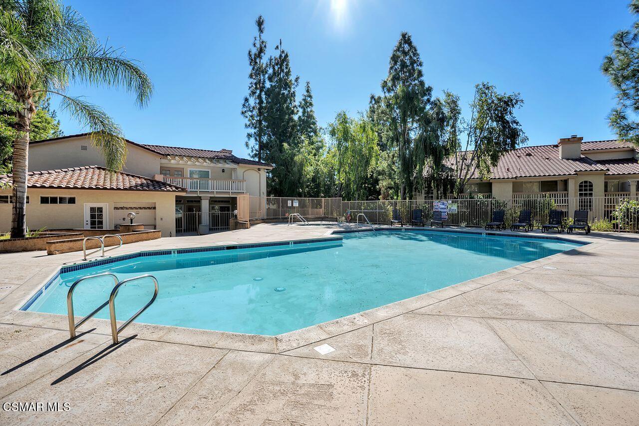697 Sutton Crest Trail, Unit 302 Oak Park, CA 91377 - Photo 42 of 47 a view of house with swimming pool outdoor seating