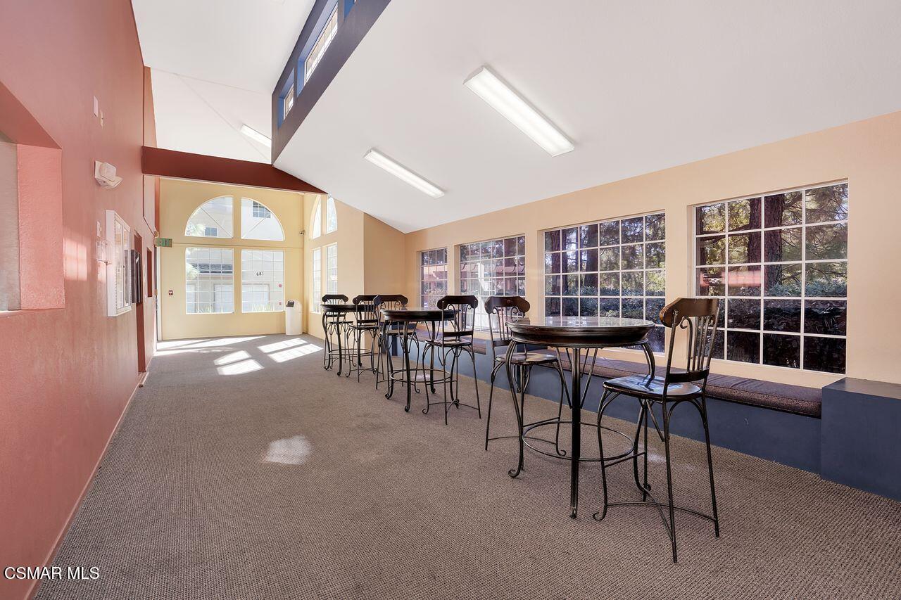 697 Sutton Crest Trail, Unit 302 Oak Park, CA 91377 - Photo 44 of 47 a dining room with furniture and a large window
